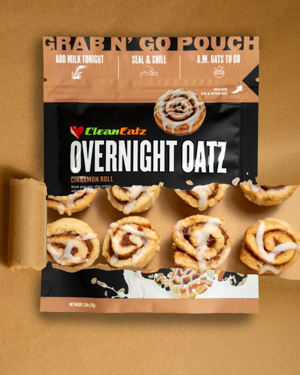 “Clean Eatz Overnight Oatz Cinnamon Roll grab-n-go pouch with mini iced cinnamon rolls pictured through the front window on a tan background.